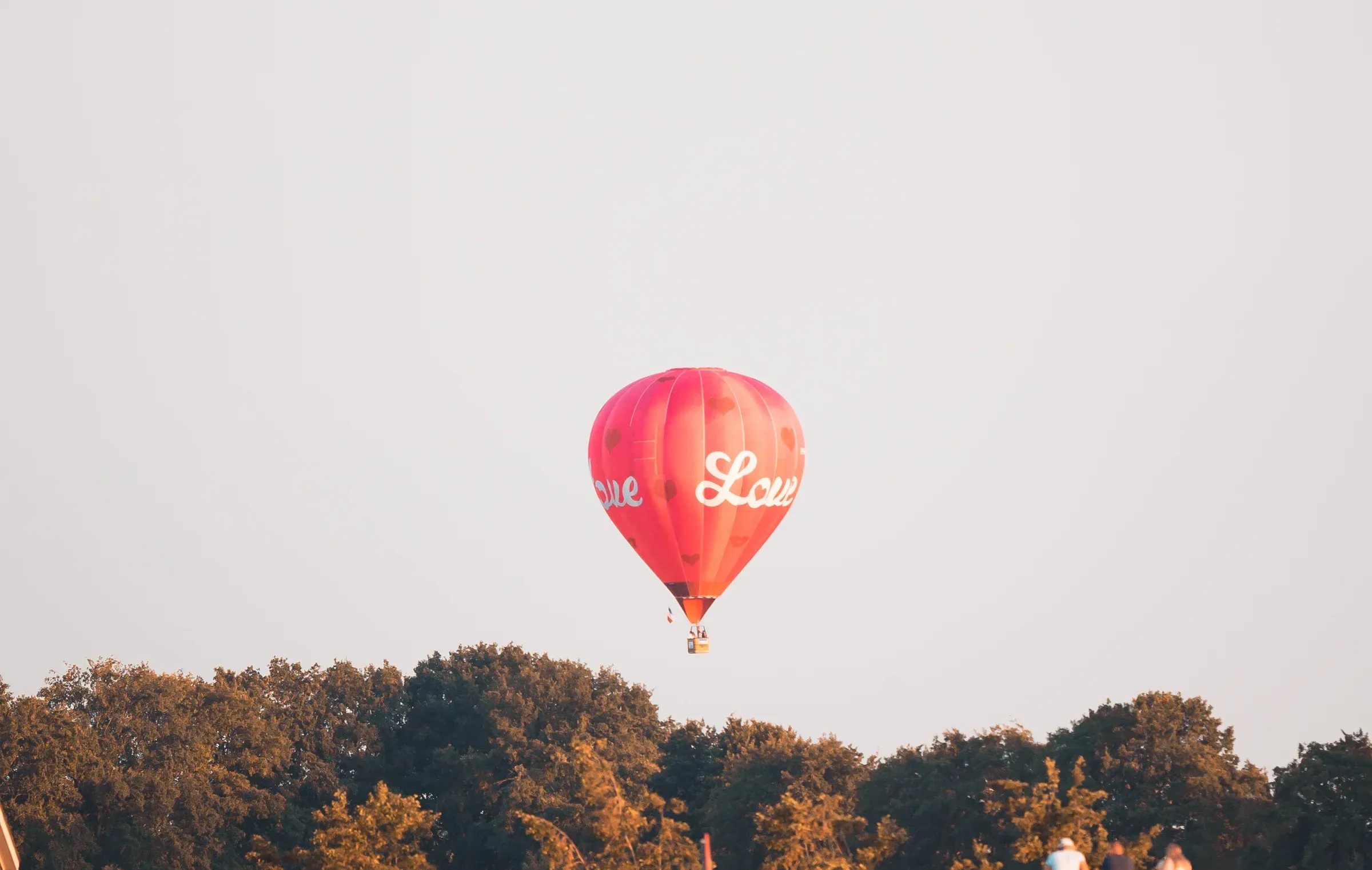 Second hot-air balloon in flight with warmer light, companion frame from the festival